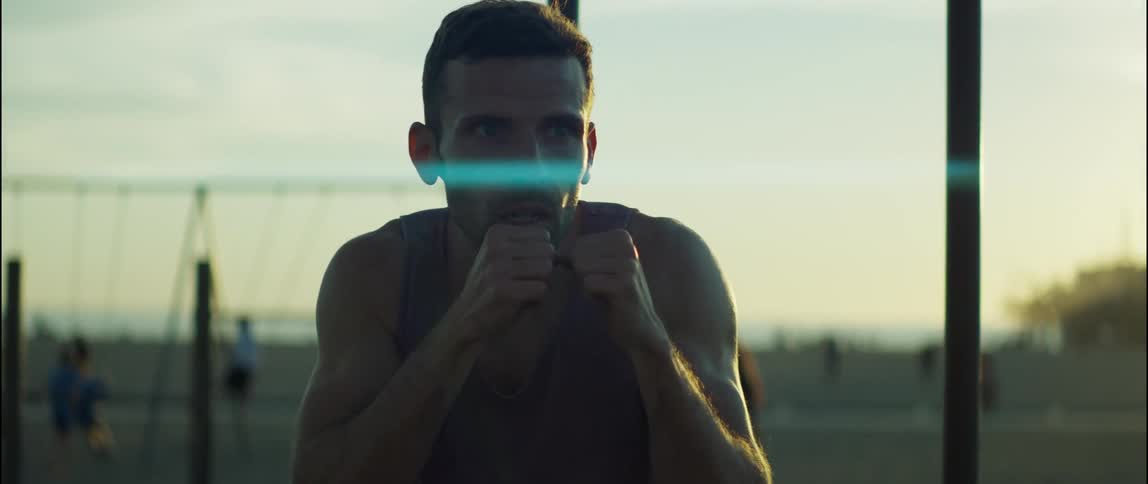 A man punches and ducks as he works out shadow boxing at the playground