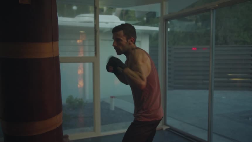 A man is punching the punching bag