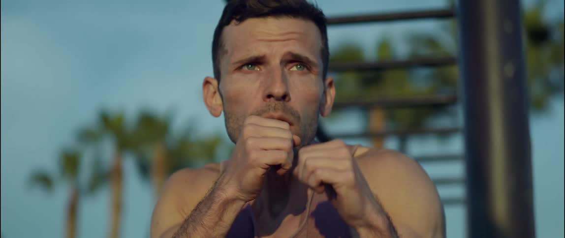 A man is boxing outdoors in the spring time