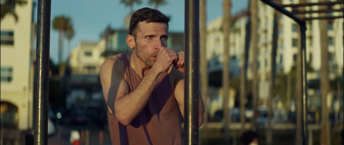 A man is exercising outdoors in a city