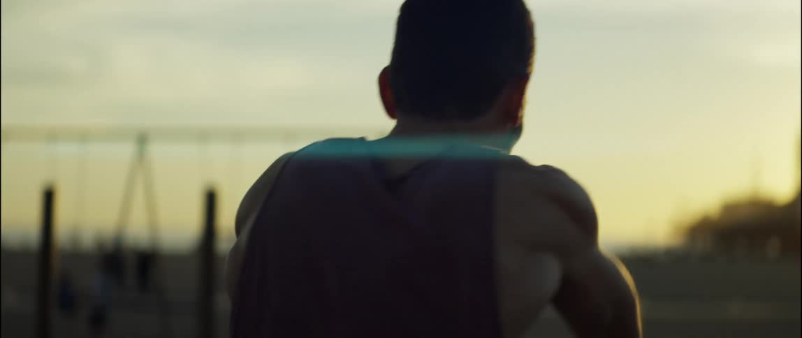 A man is near an amusement park as he exercises and shadow boxes