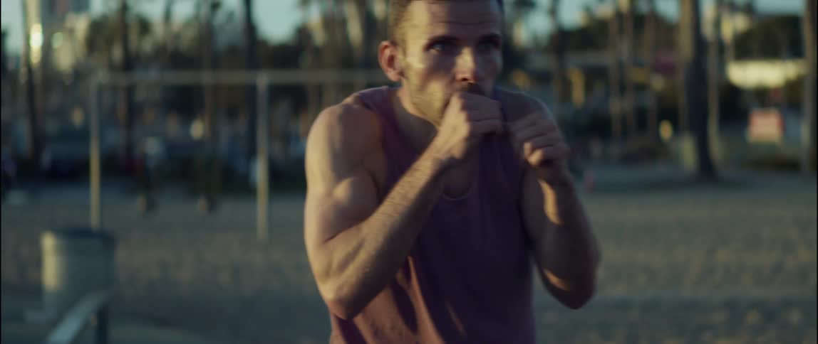 A man is shadowboxing in the park