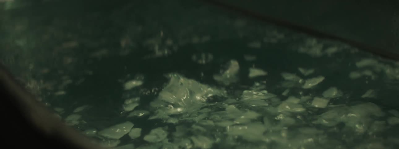 Ice being poured into a container of water