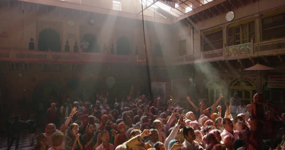 A jubilant audience dance as the sun shines