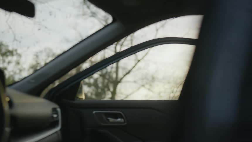 A man and woman run towards a car and the man gets in as the woman goes towards the drivers side
