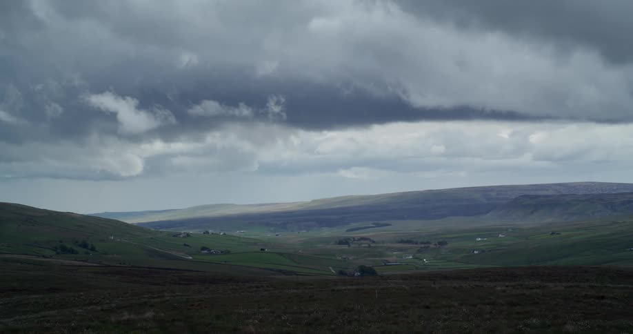 Single family homes sit among rolling hills in the countryside