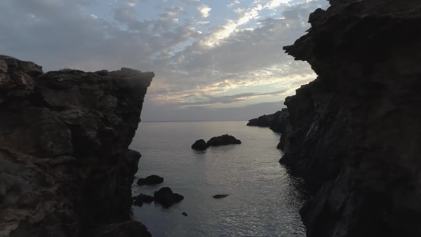 Waves move between two cliffs along the coast