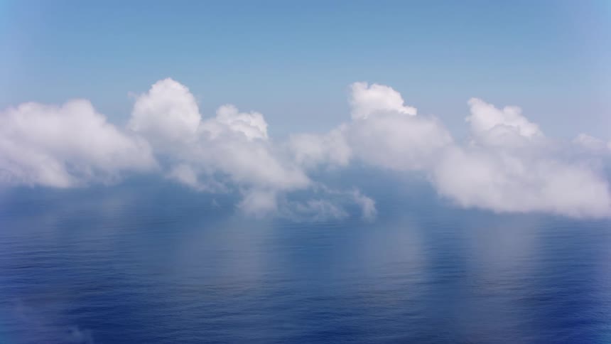 Clouds float above the ocean