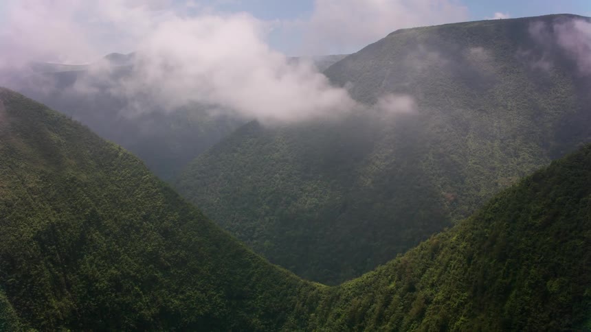 Clouds moving over grassy hills