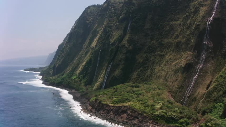 Aerial view of a tall mountain on the coast close to the ocean