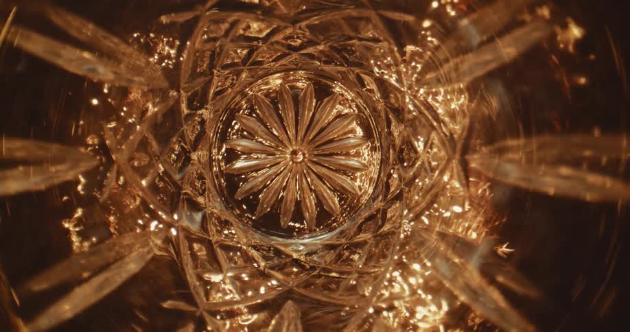 Sparkling light is seen through the inside of a piece of glassware