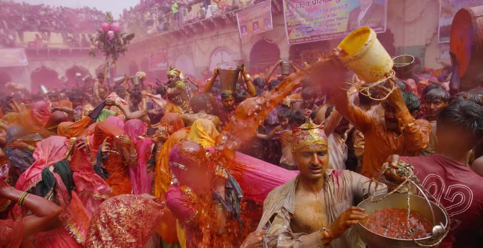 A crowd is dancing in colored water