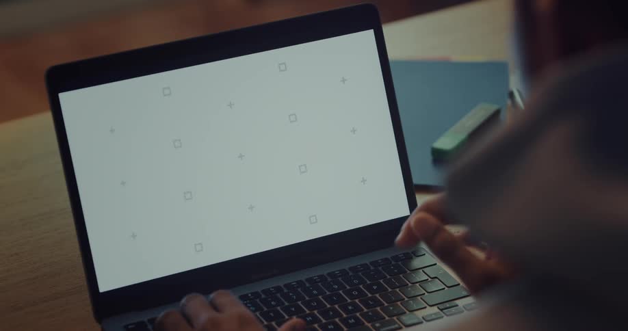 Hands typing on a laptop keyboard