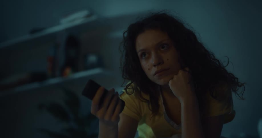 A woman laying in bed suddenly sits up