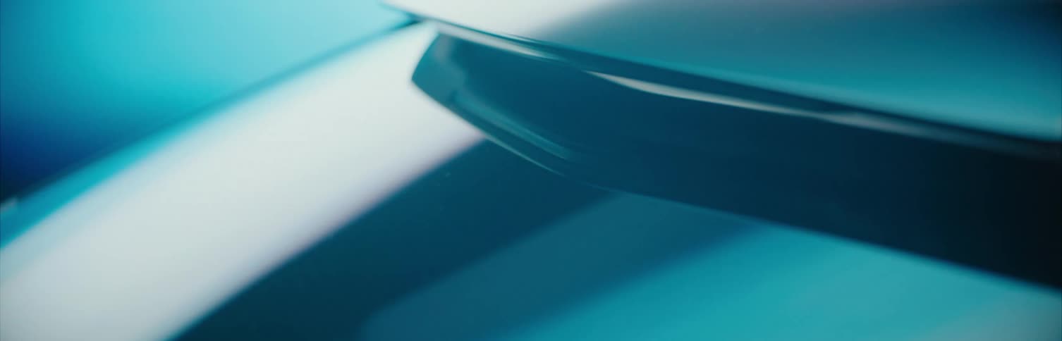 Shiny car exterior reflects colored lights