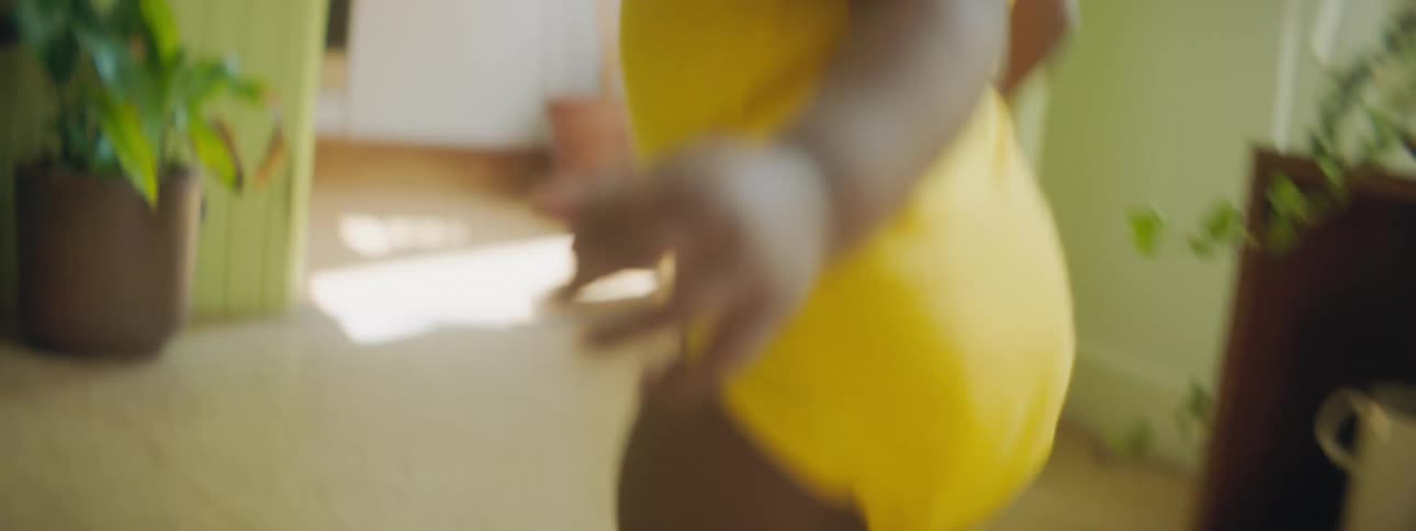 A child is walking back and forth in the living room
