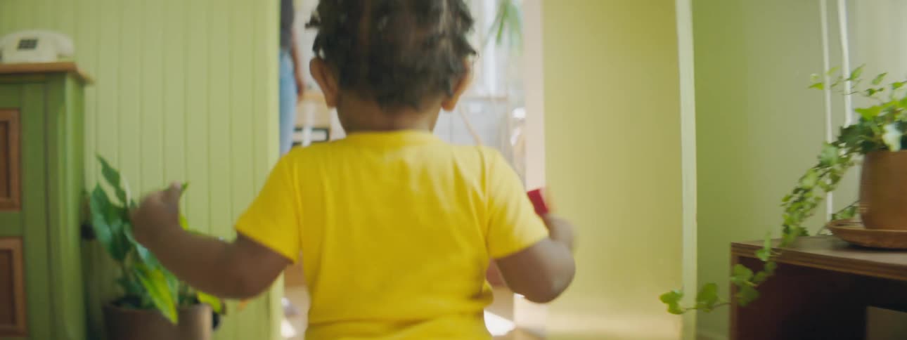 Toddler runs through house to kitchen to join mother