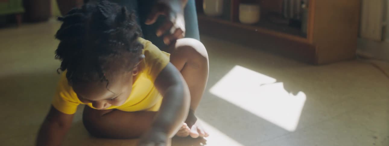 A child gets up and runs from the floor