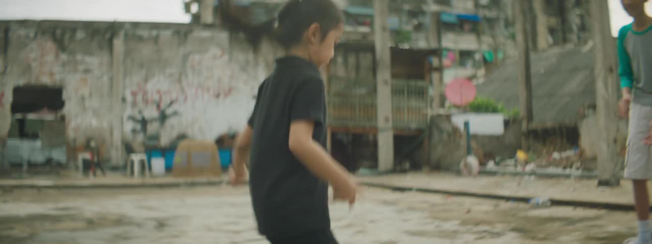 A boy and a girl play hopscotch together