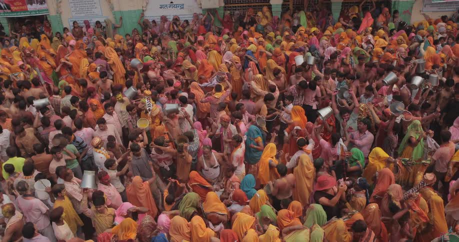 A crowd of people dance and celebrate