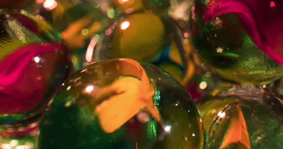 Light shines on stacked glass balls containing colorful petals