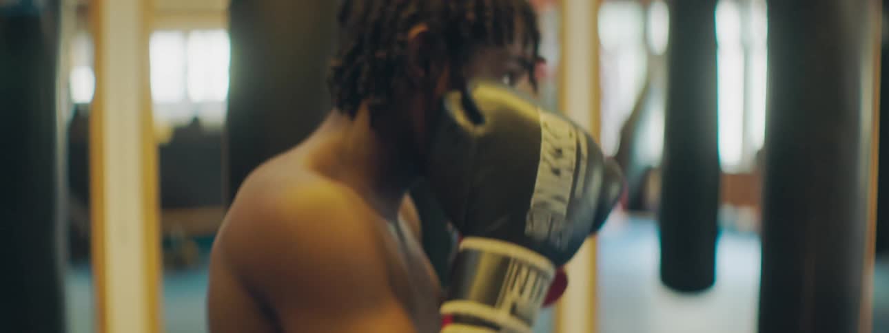A boxer throws punches in a gym