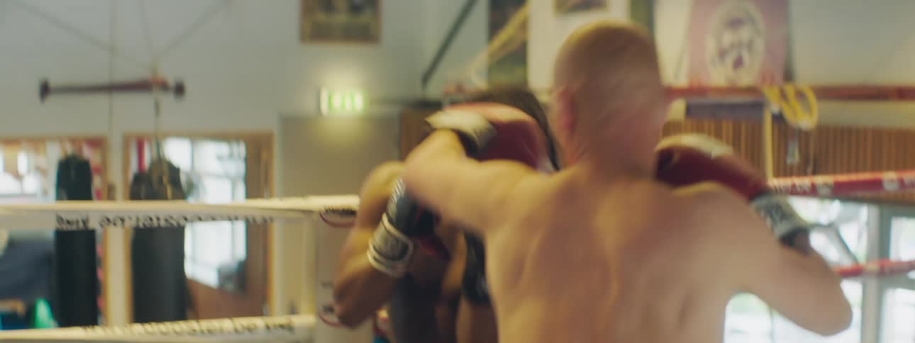 Two men are boxing in the ring