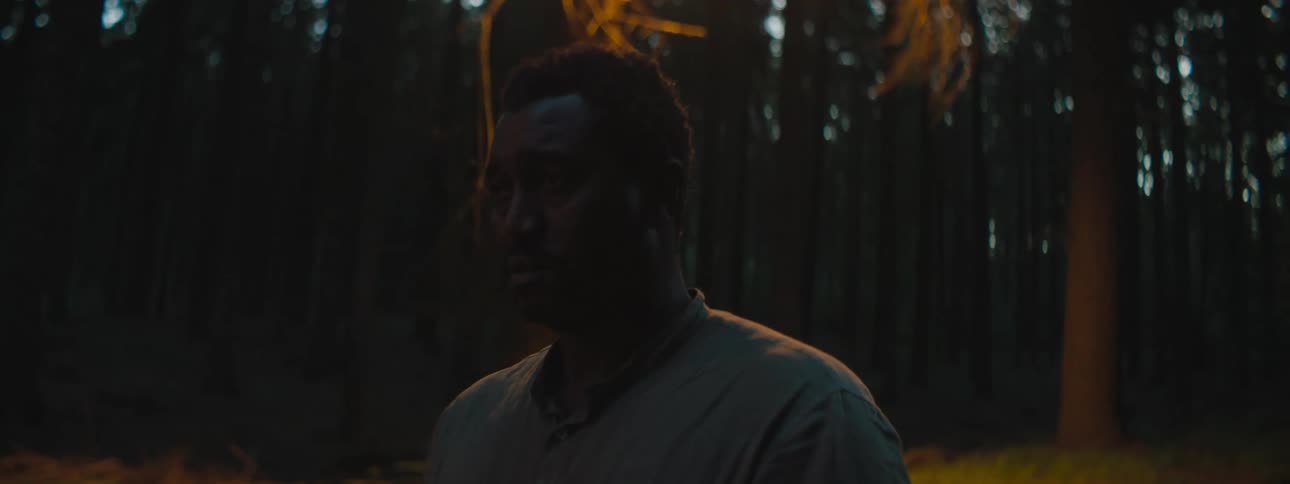 A man is standing outdoors at night