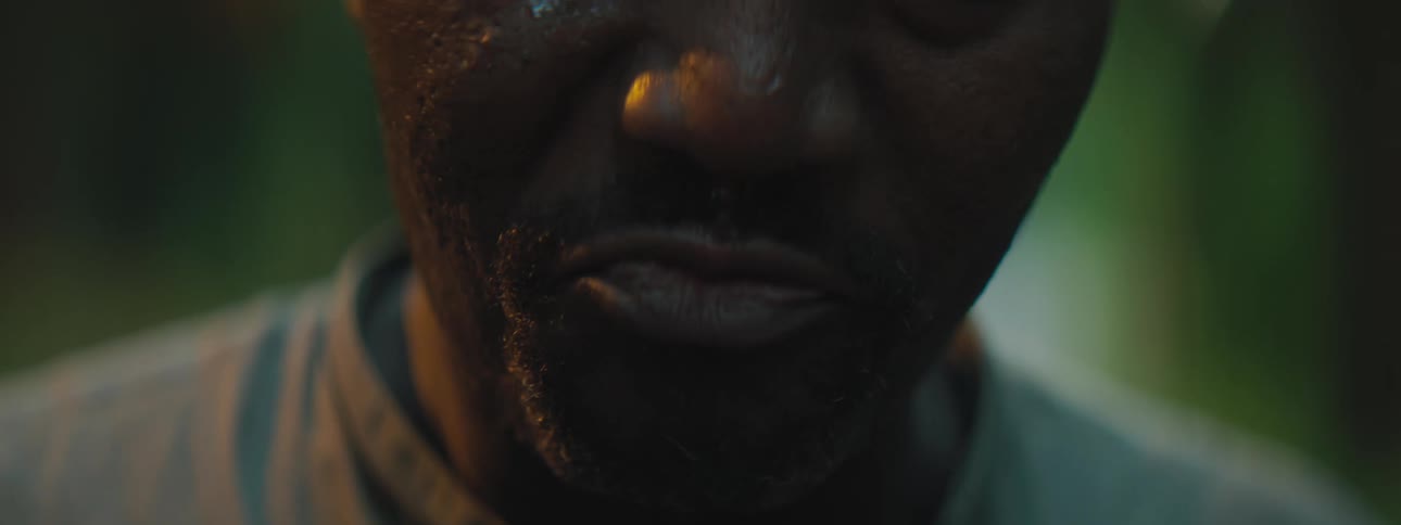 A man with tears on his cheeks standing outside