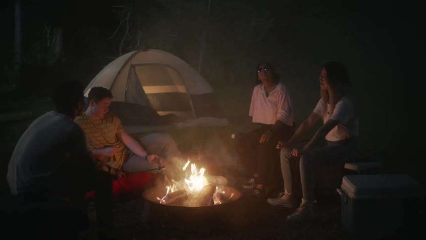 People are sitting around a campfire