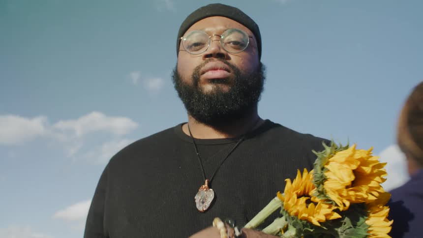 People take the flowers from the mans arms