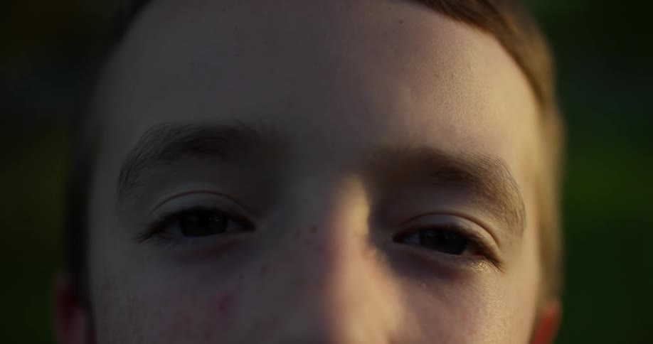 A child is blinking his eyes
