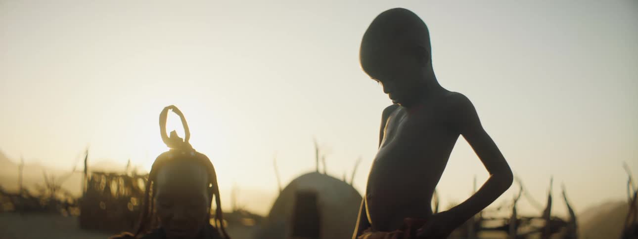 Mother sitting beside son in rural area