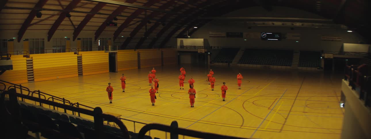People in a gymnasium practicing choreography