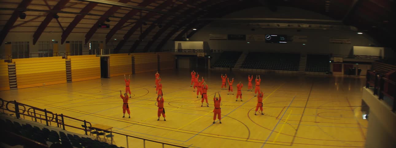 People in a gymnasium practicing choreography