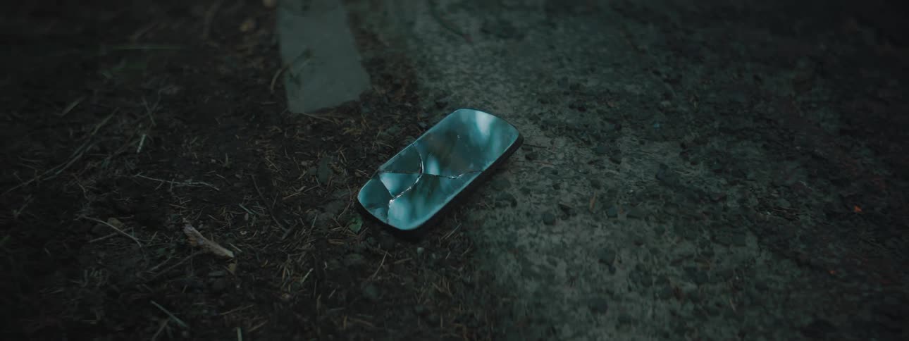 A broken piece of glass on the ground outside
