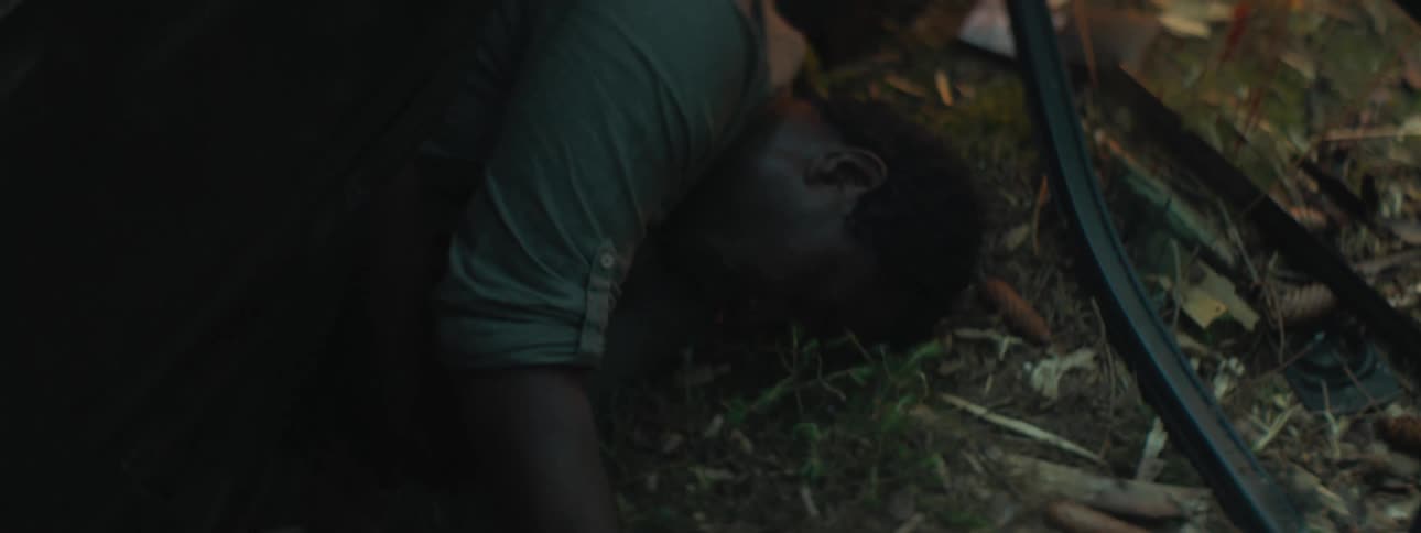 The body of a man is on the ground near to a piece of glass with blood on it