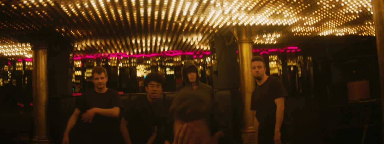 A man is break dancing as others watch