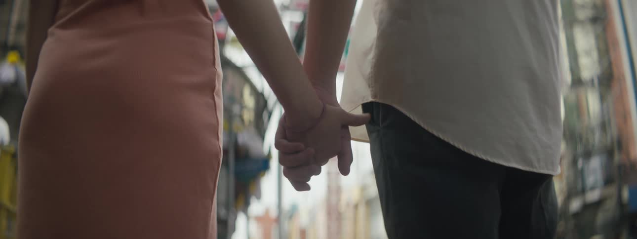 Two people hold hands in the intersection