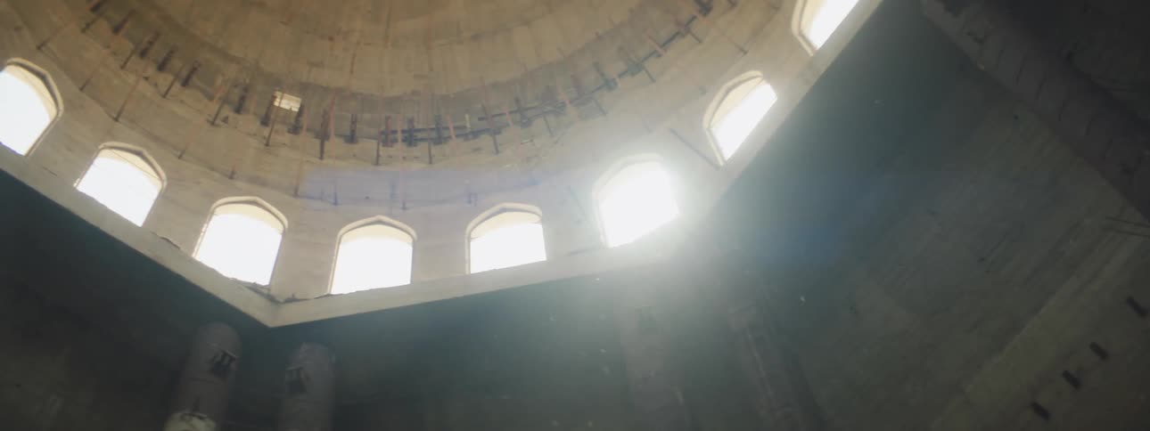 The inside of a building with a dome and windows