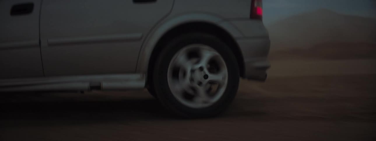 Car travels over the dirt road in the desert
