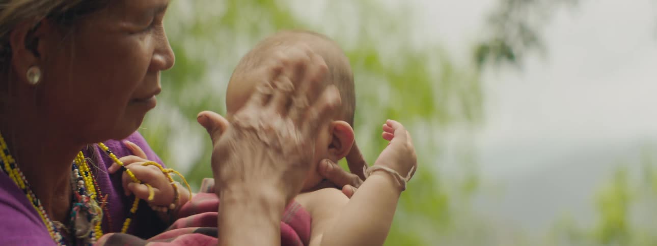 Grandmother tending to infant grandchild
