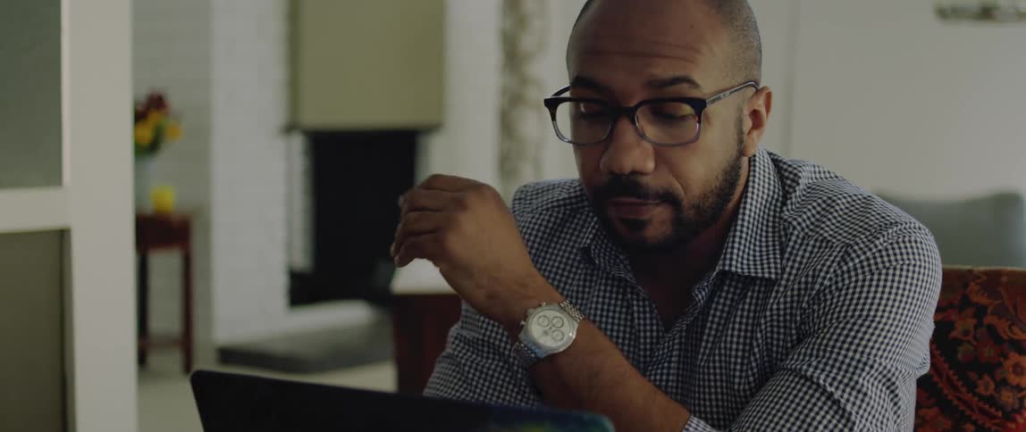 A man using a laptop in a room