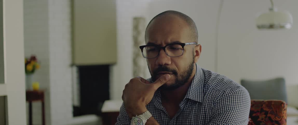 A man sits and thinks at his dining room table