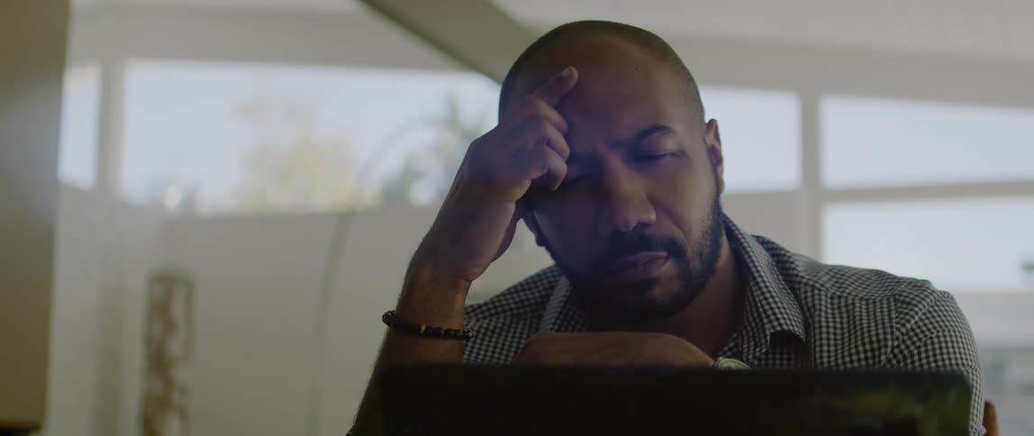 A man sitting around looking at a computer