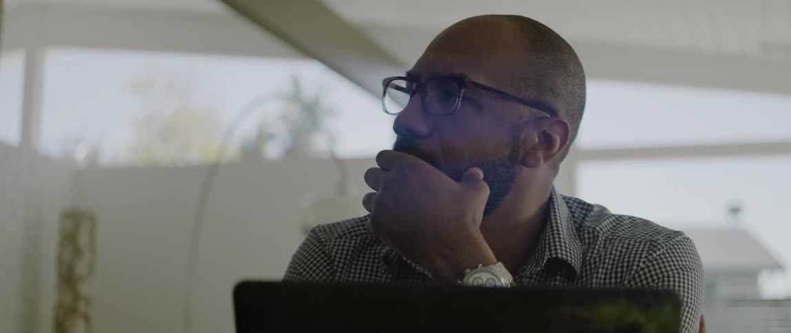 A man sitting around using a laptop