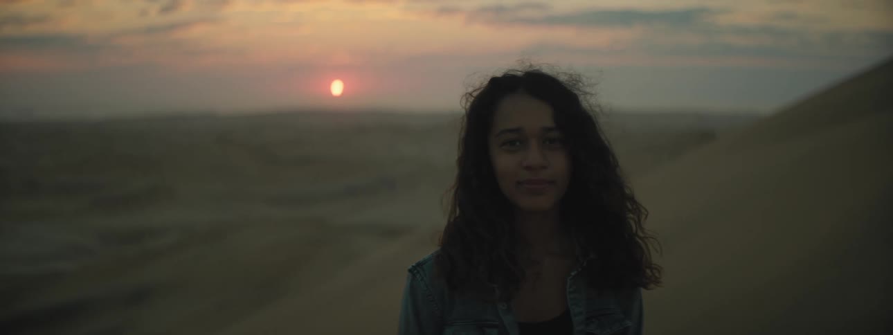 A girl smiles in the desert
