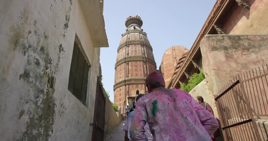 A man climbs steps towards a tower