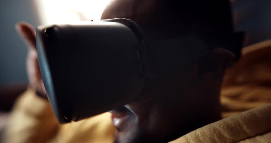 A man looks over at his friend then both put their vr glasses on to play