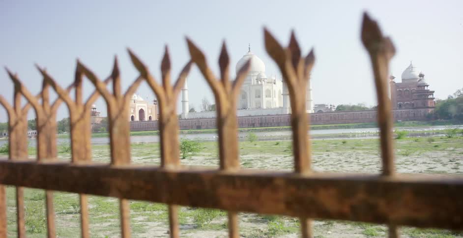 Large buildings sit in the distance beyond this gate